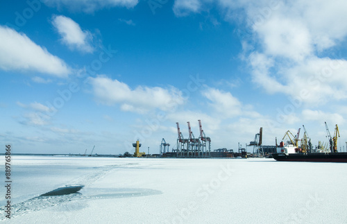 Winter shipping. Big cargo ships in frozen ice sea fairway