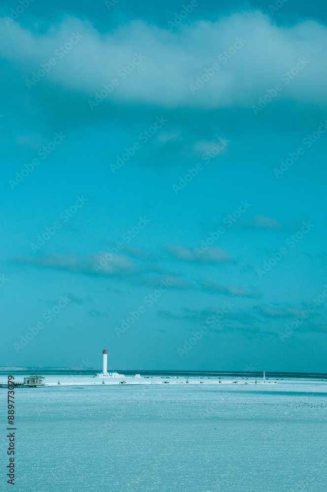 Vorontsov Lighthouse near Odessa in the Black Sea. Blue Sky background with white clouds. Vorontsov Lighthouse near Odessa in the Black Sea. Blue Sky background with white clouds.