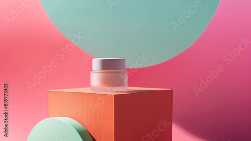 A Glass Skincare Facial Cream Jar Mockup Displayed on a Orange Podium Against A Vibrant Pink and Teal Green Background with Geometric Shapes. Minimal Cosmetic Beauty Product Branding.