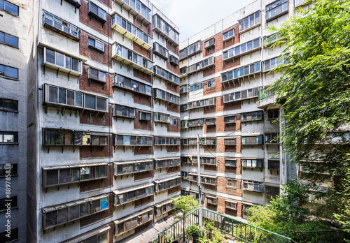 Toegye-ro, Jung-gu, Seoul, South Korea - June 13, 2023: High angle view old window and wall of 2nd Model Apartment of Hoehyeon-dong with trees
 photo