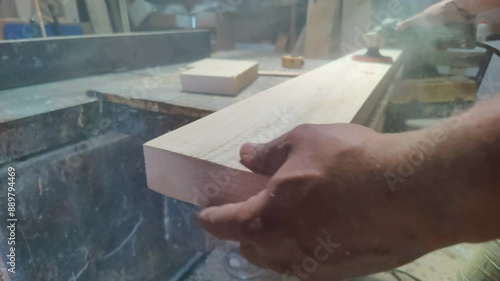 Shaping a Piece of Wood with a Sander in a Carpenters Workshop Footage.