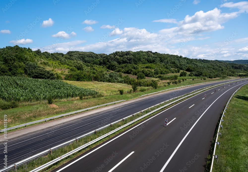 Empty open highway through pastoral landscape Empty open highway through pastoral landscape