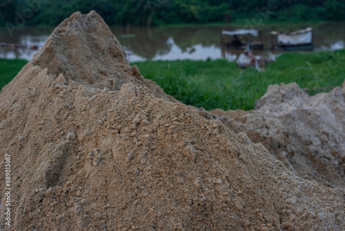 A sand quarry site in the background thick green forest with blue sky - Ogun State, Nigeria on July 09, 2024. photo