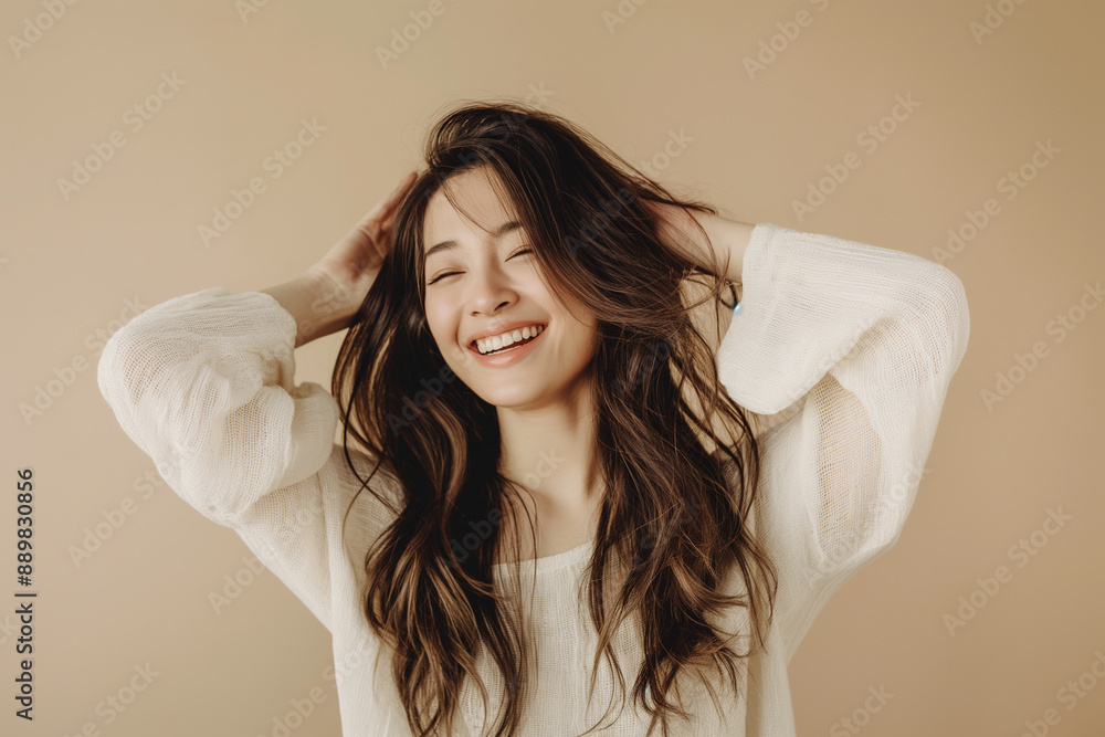 Young Asian Woman with Long Wavy Hair, Natural Beauty, Soft Lighting, Minimalist Background, Studio Portrait, Professional Model, Serene Expression, Timeless Elegance, Fashion Photography. Young Asian Woman with Long Wavy Hair, Natural Beauty, Soft Lighting, Minimalist Background, Studio Portrait, Professional Model, Serene Expression, Timeless Elegance, Fashion Photography.