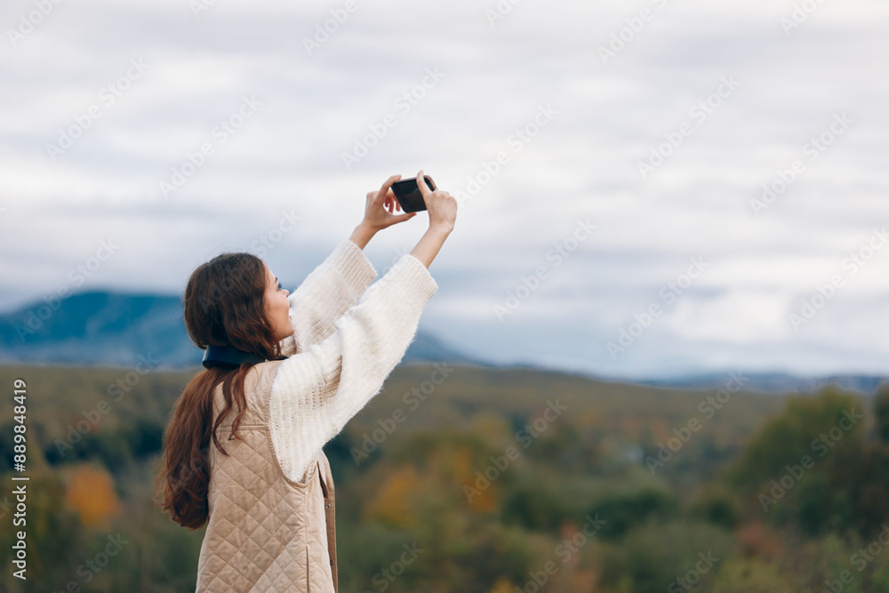 Mountain Freedom: Adventurous Woman Embracing Nature, Smiling and Taking Selfie with Phone in Beautiful Landscape Mountain Freedom: Adventurous Woman Embracing Nature, Smiling and Taking Selfie with Phone in Beautiful Landscape