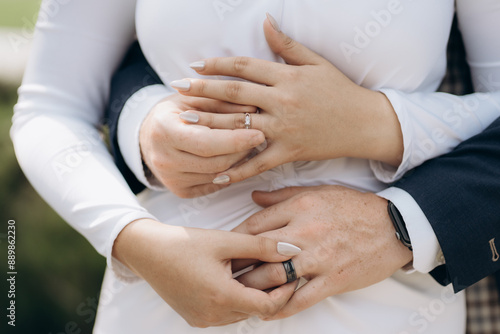 Newly wed couple's hands with wedding rings