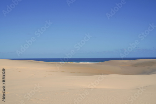 High angle view of sand dunes of Port Stephens Desert against blue sea and sky at Sydney, New South Wales, Australia 