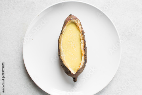 Obraz na plátně Overhead view of baked sweet potato crème brûlée on a white plate, top view of a
