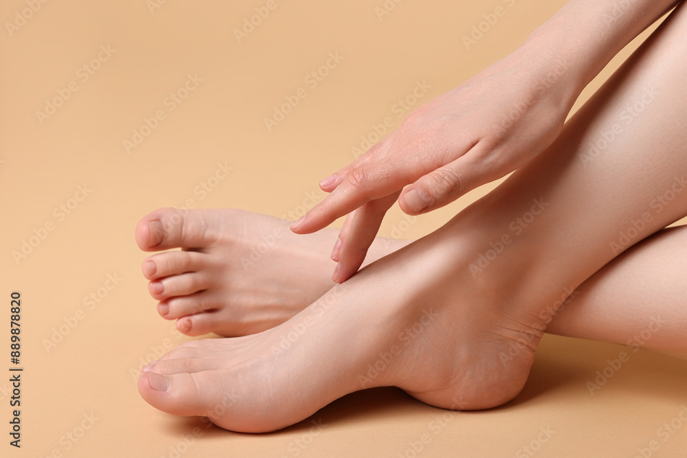 Closeup view of woman`s groomed feet after care procedure on beige background Closeup view of woman`s groomed feet after care procedure on beige background