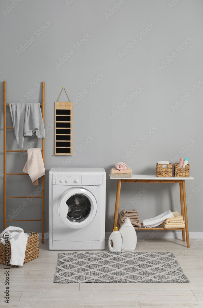 Obraz premium Washing machine, ladder, detergents, basket, laundry and storage bench indoors