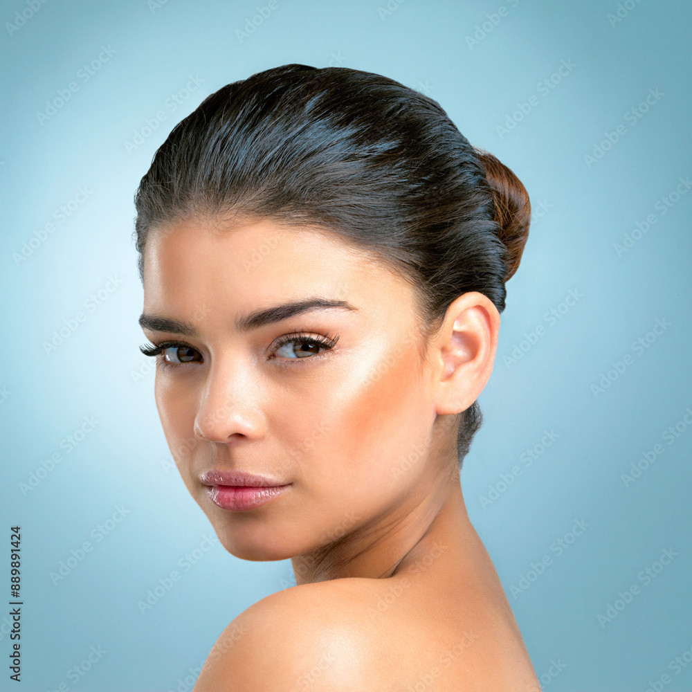 Naklejka premium Blue background, portrait and girl with skincare for glow, natural beauty and self care with pride. Female model, treatment and results for face wellness, cosmetics and confidence of woman by studio