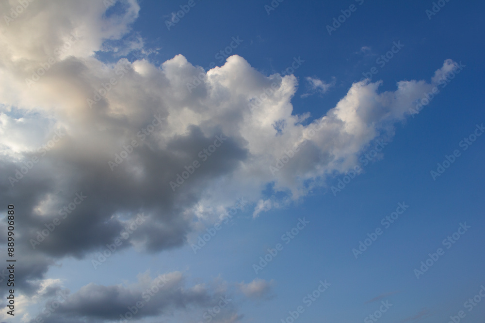 It's a blue sky with atmospheric puffy clouds. It's a blue sky with atmospheric puffy clouds.