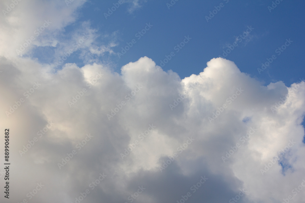 It's a blue sky with atmospheric puffy clouds. It's a blue sky with atmospheric puffy clouds.