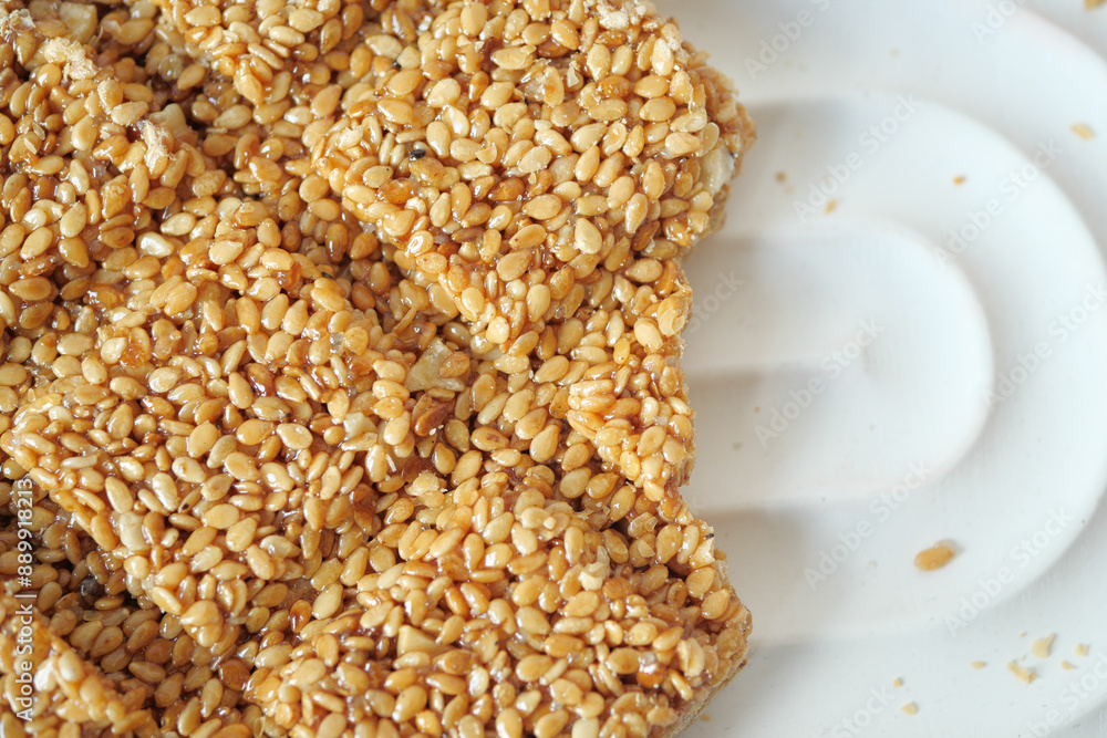 This is a delightful closeup photograph showing a homemade sesame seed brittle treat This is a delightful closeup photograph showing a homemade sesame seed brittle treat