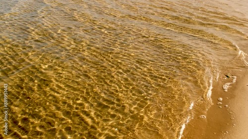 Seawater flows into estuary intertidal zone with abstract sand patterns photo