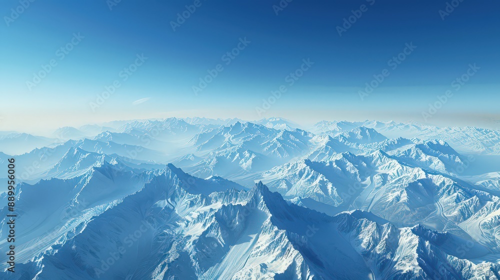 Present an aerial perspective of a serene mountain range, its peaks dusted with snow, against a clear blue sky backdrop Present an aerial perspective of a serene mountain range, its peaks dusted with snow, against a clear blue sky backdrop