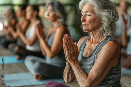 Group of seniors participating in a yoga class photo