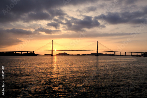 Sunset view of pier and pillars of Mokpo Bridge on the sea at Mokpo-si, South Korea
 photo