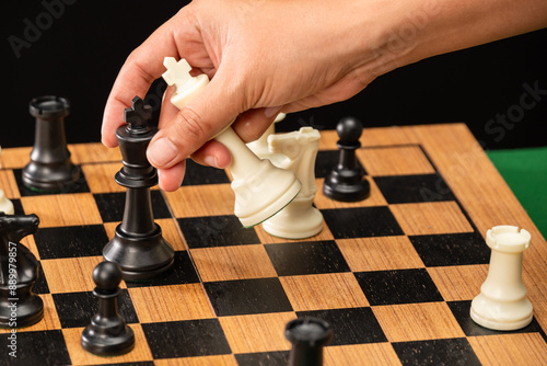 The hands of man on the competition and the strategic planning guidelines on the checkmate board. Succeed