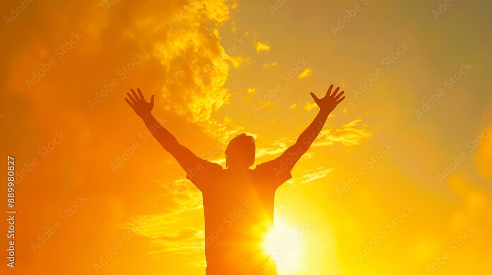 A man with his arms raised in the sun. A man with his arms raised in the sun.