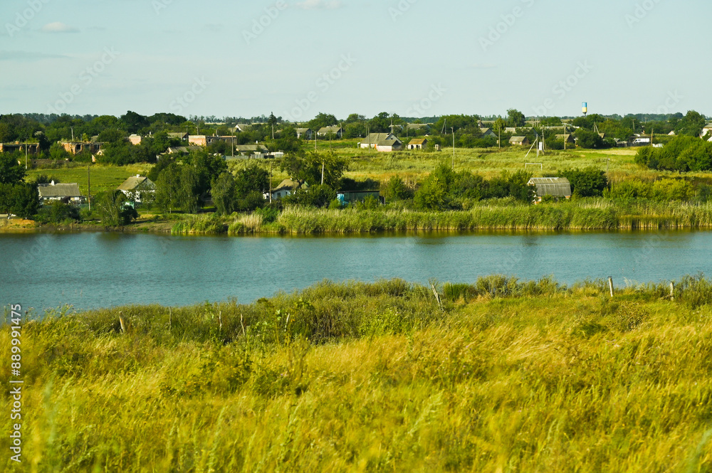 a river in the Ukrainian steppe. a village on the shore a river in the Ukrainian steppe. a village on the shore