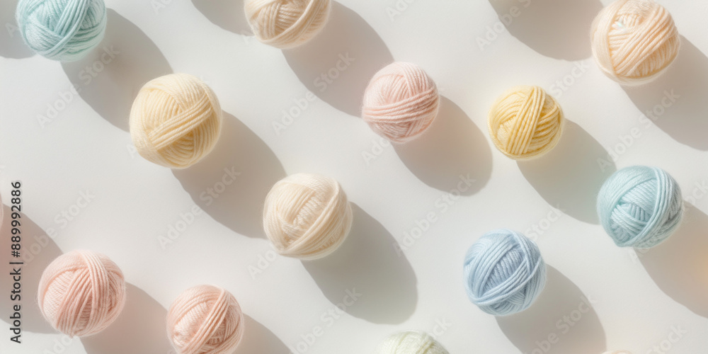 A background of pastel-colored alpaca yarn balls, each with its shadow, scattered across the canvas in an elegant display, with soft shadows on a white background A background of pastel-colored alpaca yarn balls, each with its shadow, scattered across the canvas in an elegant display, with soft shadows on a white background