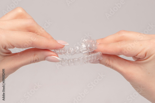 Transparent mouth guard in a woman's hand isolated. photo