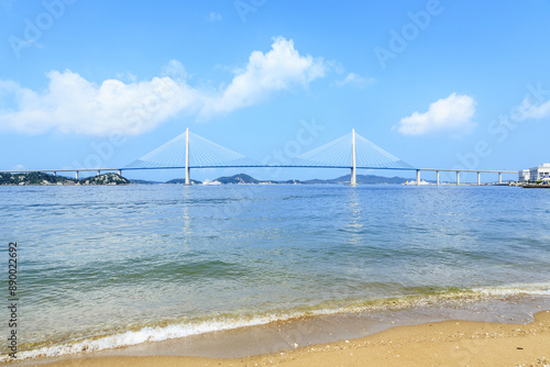 Summer view of wave on sandy beach against Mokpo Bridge on the sea at Yudal Beach of Jukgyo-dong near Mokpo-si, South Korea
 photo