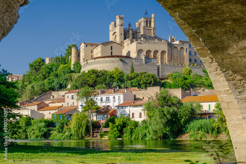 Pont Vieux- A bridge spans a river with a castle in the background