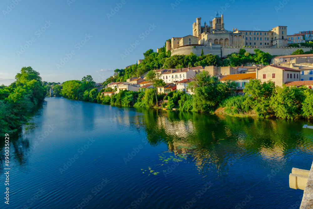 Cathedral Saint-Nazaire-A river runs through a town with a castle in the background Cathedral Saint-Nazaire-A river runs through a town with a castle in the background