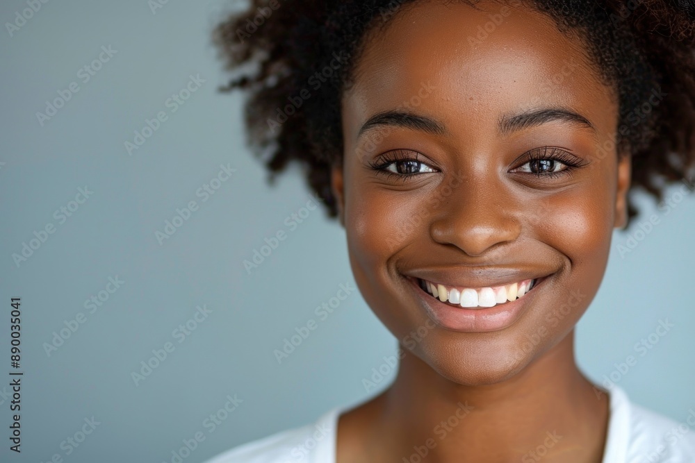 A close-up portrait of a person smiling happily against a solid background. The joyful expression radiates positivity, capturing the essence of genuine happiness. The clear background emphasizes the A close-up portrait of a person smiling happily against a solid background. The joyful expression radiates positivity, capturing the essence of genuine happiness. The clear background emphasizes the