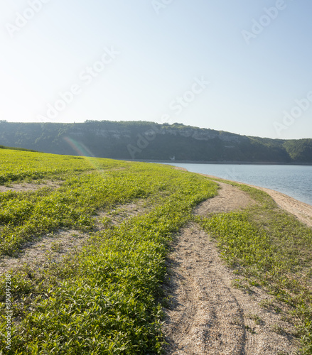 A grassy shore of the Dniester River in the morning