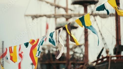 Mutliple sea flags hanging with the ship in the background photo