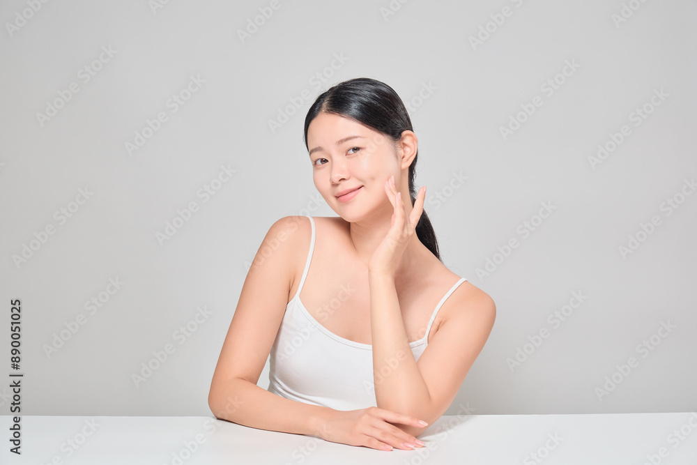 Asian female model lightly touching her skin. Korean cosmetics model. Asian female model lightly touching her skin. Korean cosmetics model.