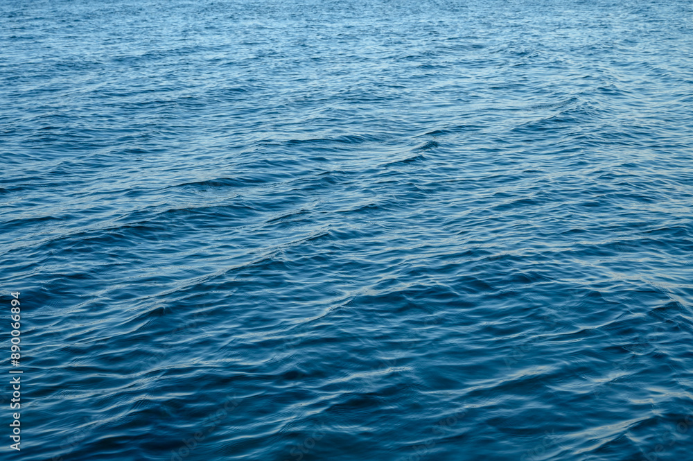 The view through a viewing port between floor, bottom and surface of luxury swimming pool and blue wate