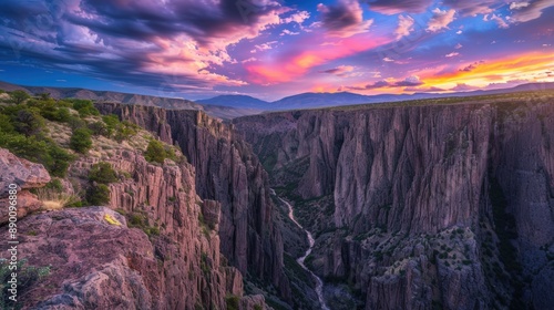 A beautiful sunset over a canyon with a river running through it