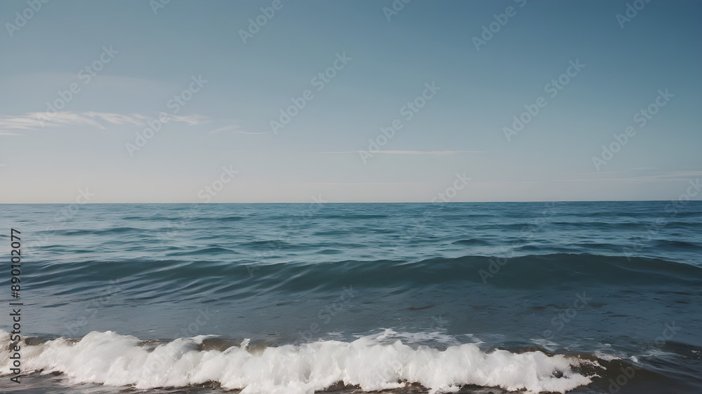 Calm ocean waves with a blue sky background Calm ocean waves with a blue sky background