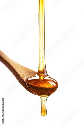 Honey dripping from a wooden isolated on a white background © Davy