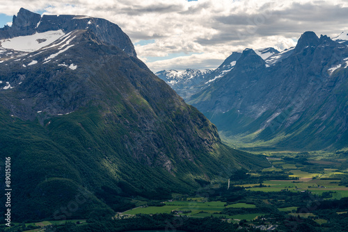 view from above over Andalsnes in Rauma in Norway on fjord valley on a sunny summer day with mountains in the background