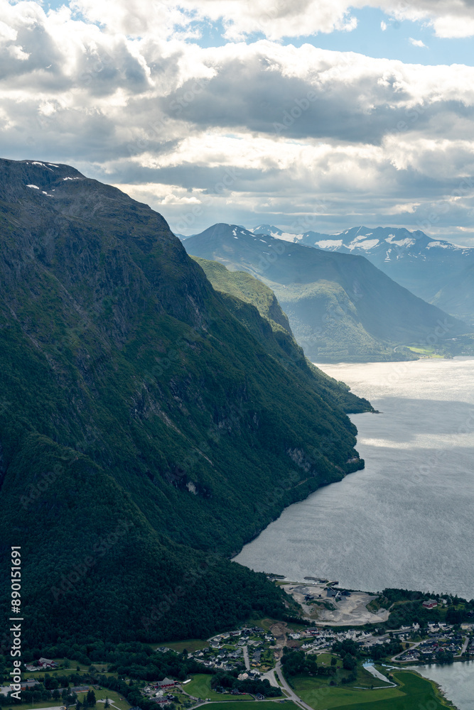 Fototapeta premium view from above over Andalsnes in Rauma in Norway on fjord valley on a sunny summer day with mountains in the background