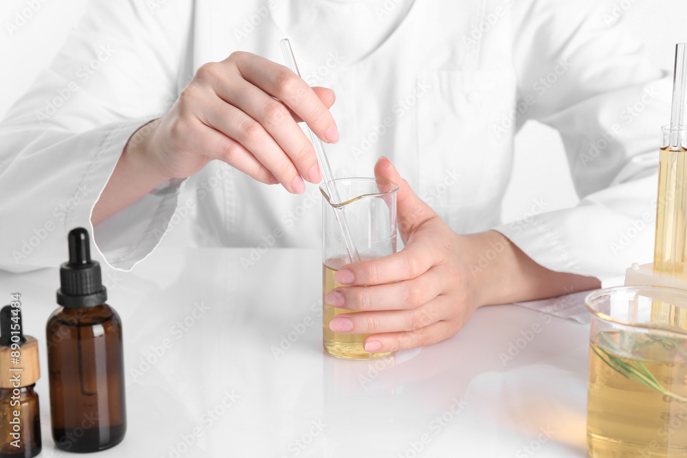 Aromatherapy product. Scientist developing essential oils at white table in laboratory, closeup Aromatherapy product. Scientist developing essential oils at white table in laboratory, closeup