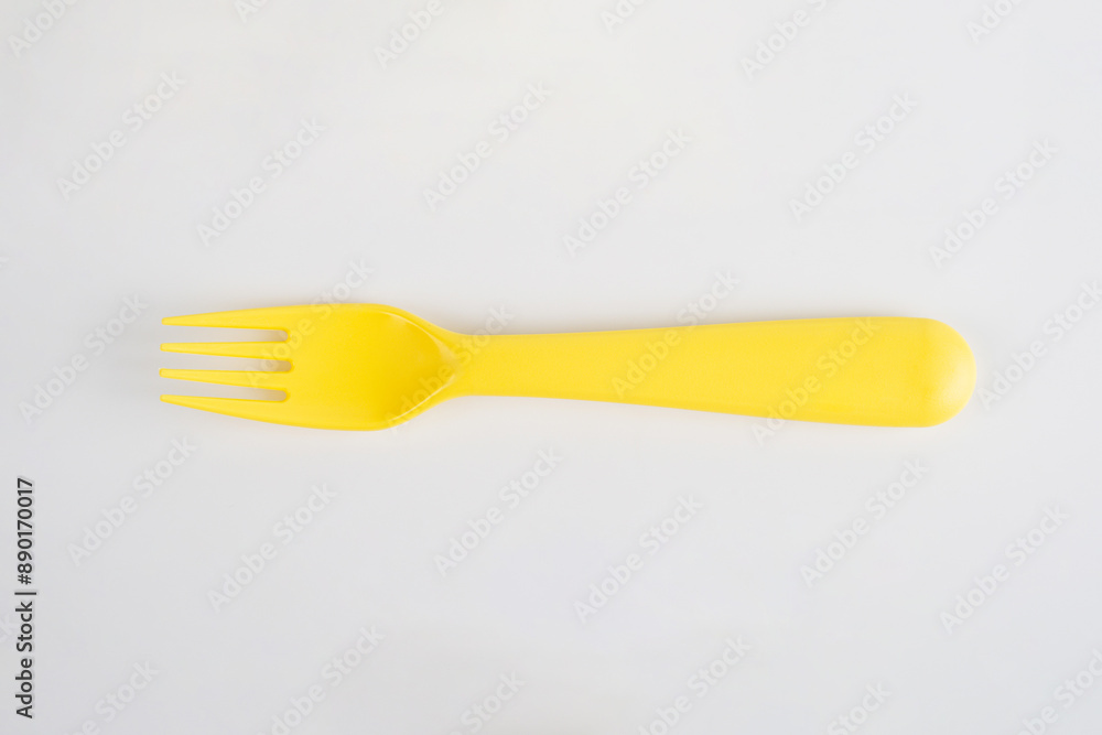 Yellow fork and spoon isolated on white background. Yellow fork and spoon isolated on white background.