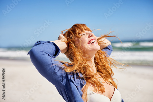 Happy young woman enjoying sun at summer beach photo