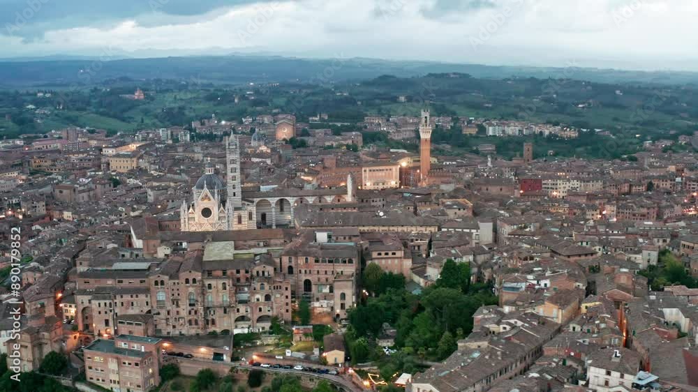 Siena city skyline aerial with view of Duomo di Siena and Mangia Tower landmarks