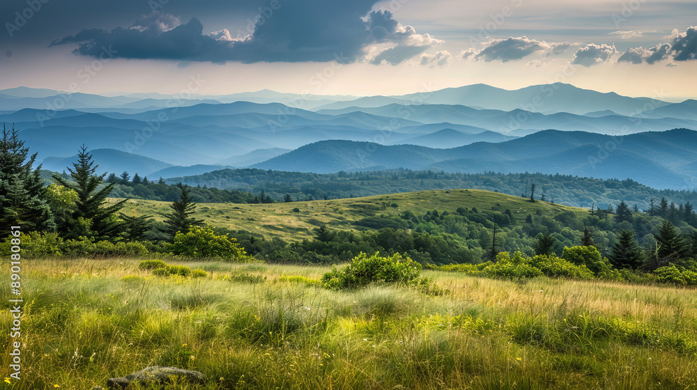 Stunning view of the Blue Ridge Mountains from the Appalachian Trail on top of Round Bald. Layers of grasslands, forests, and majestic peaks stretch into the distance. Stunning view of the Blue Ridge Mountains from the Appalachian Trail on top of Round Bald. Layers of grasslands, forests, and majestic peaks stretch into the distance.