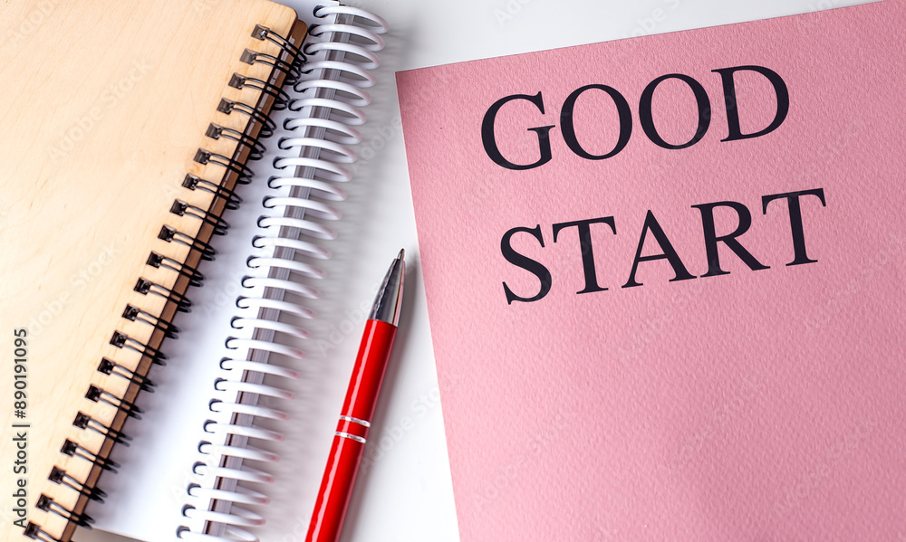GOOD START text on pink paper with notebooks GOOD START text on pink paper with notebooks