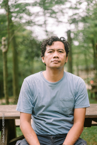 An Asian man with a blank stare, capturing an expression of contemplation or emptiness, perfect for emotional