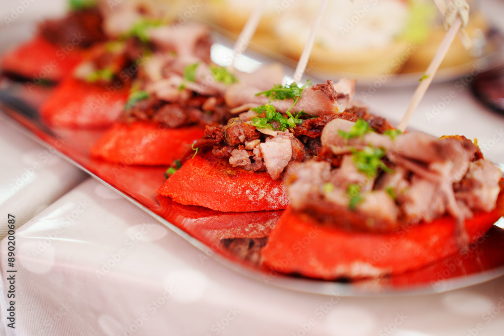 Mini red baguette sandwiches with meat. canapes for the banquet table. catering services. Mini red baguette sandwiches with meat. canapes for the banquet table. catering services.
