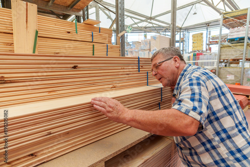 Senior Man Selecting Lumber at a Hardware Store