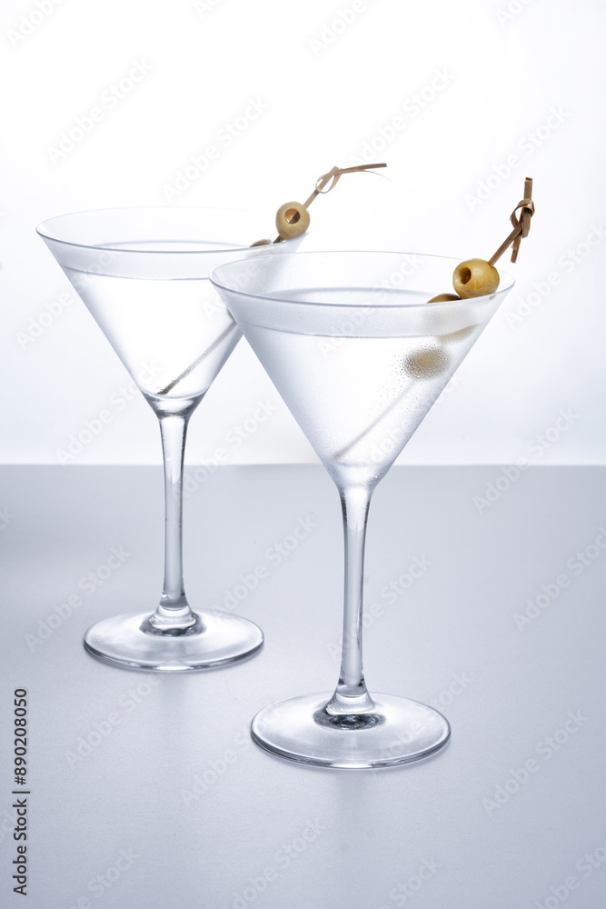 Vodka martini cocktail with vodka and vermouth and green olives isolated on white background Vodka martini cocktail with vodka and vermouth and green olives isolated on white background